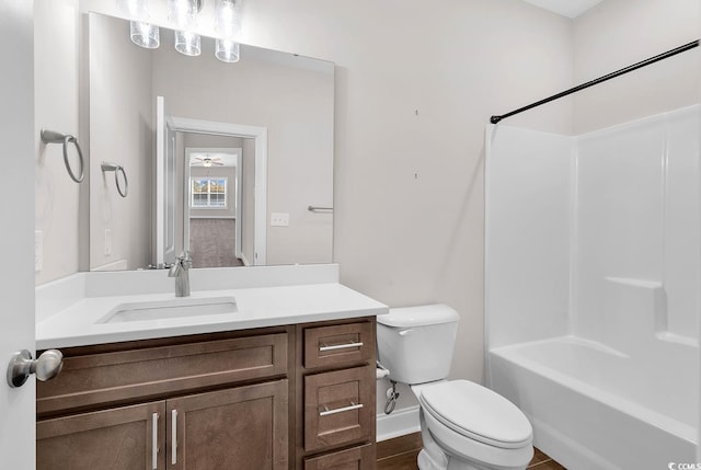 full bathroom featuring vanity, bathing tub / shower combination, and toilet