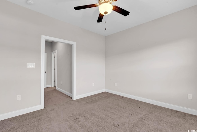 empty room featuring ceiling fan and light carpet