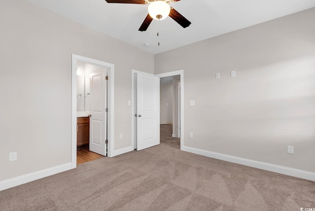 unfurnished bedroom with connected bathroom, light carpet, and ceiling fan