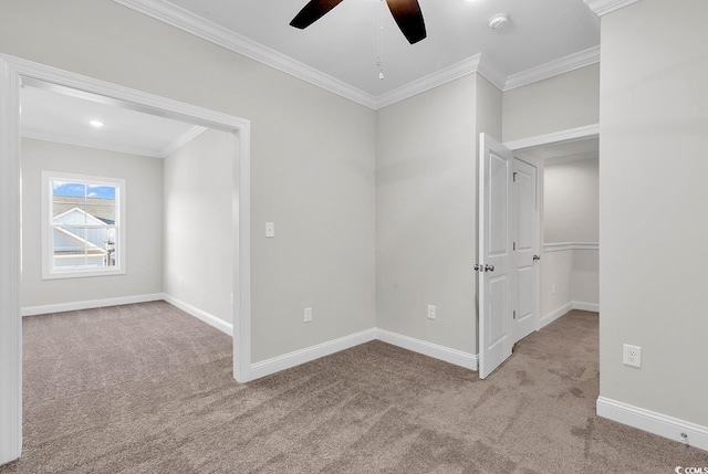 carpeted empty room featuring ornamental molding and ceiling fan