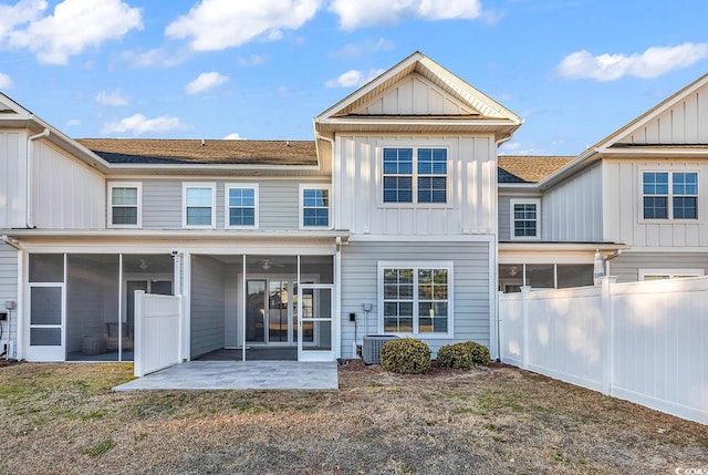 back of property featuring a sunroom and a patio area