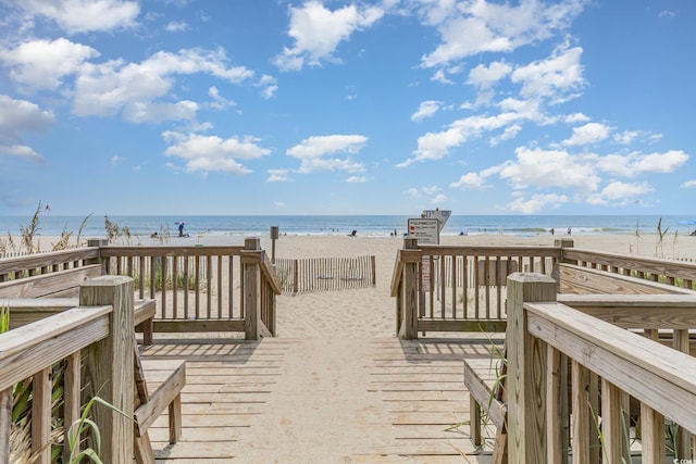 view of community with a water view and a view of the beach