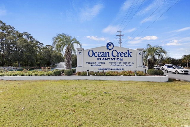 community / neighborhood sign featuring a lawn