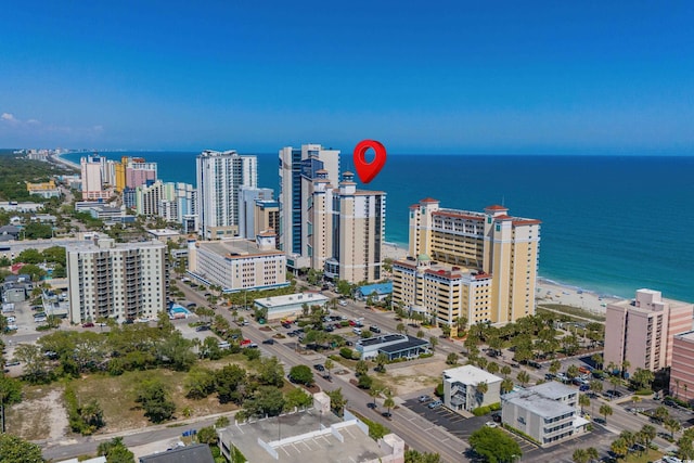 drone / aerial view with a water view and a beach view