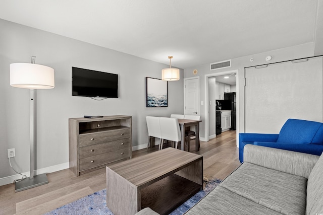 living room with light hardwood / wood-style flooring