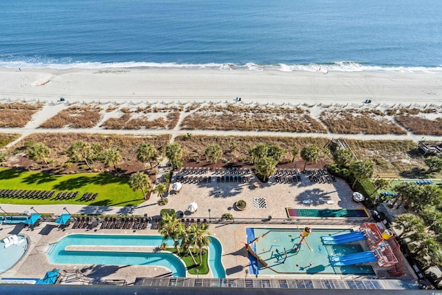 drone / aerial view with a water view and a beach view