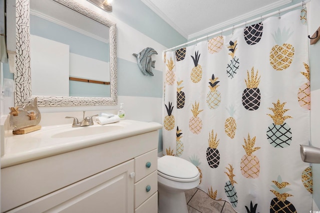 bathroom featuring crown molding, tile patterned floors, vanity, and toilet