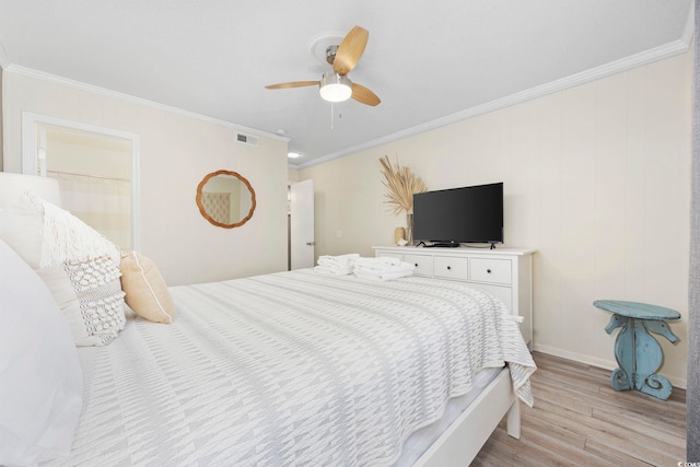 bedroom featuring ornamental molding, ceiling fan, and light hardwood / wood-style floors