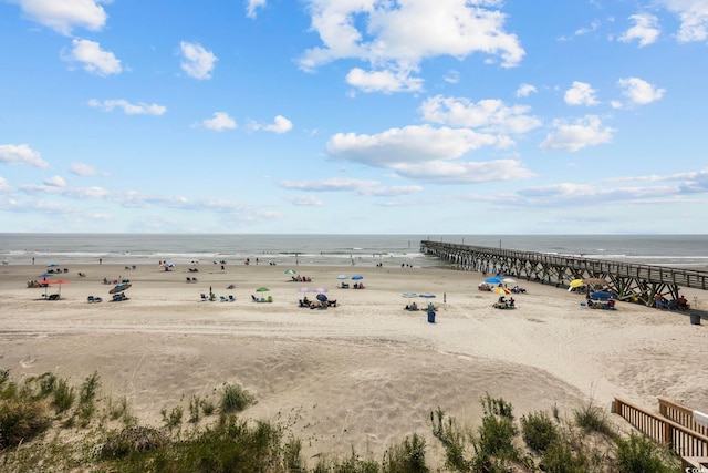 drone / aerial view featuring a view of the beach and a water view