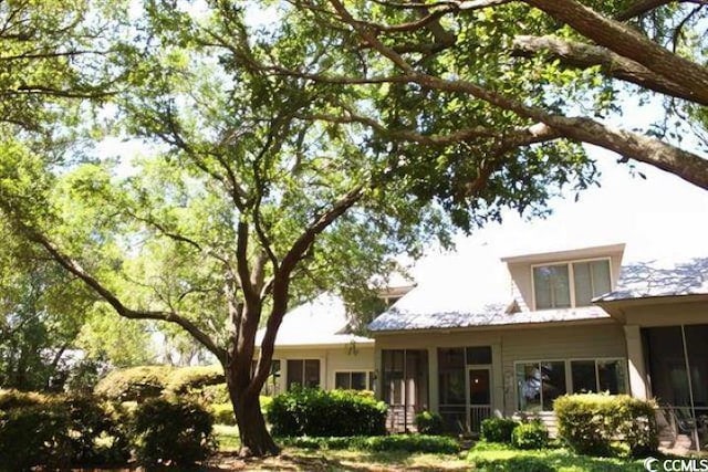 rear view of house featuring a sunroom