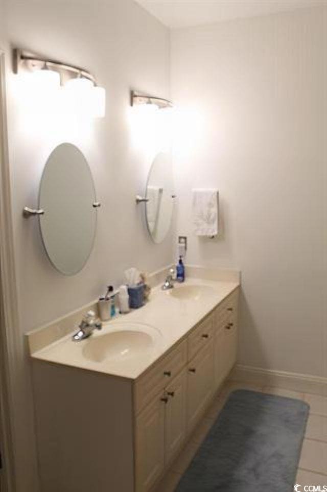 bathroom with tile patterned flooring and vanity