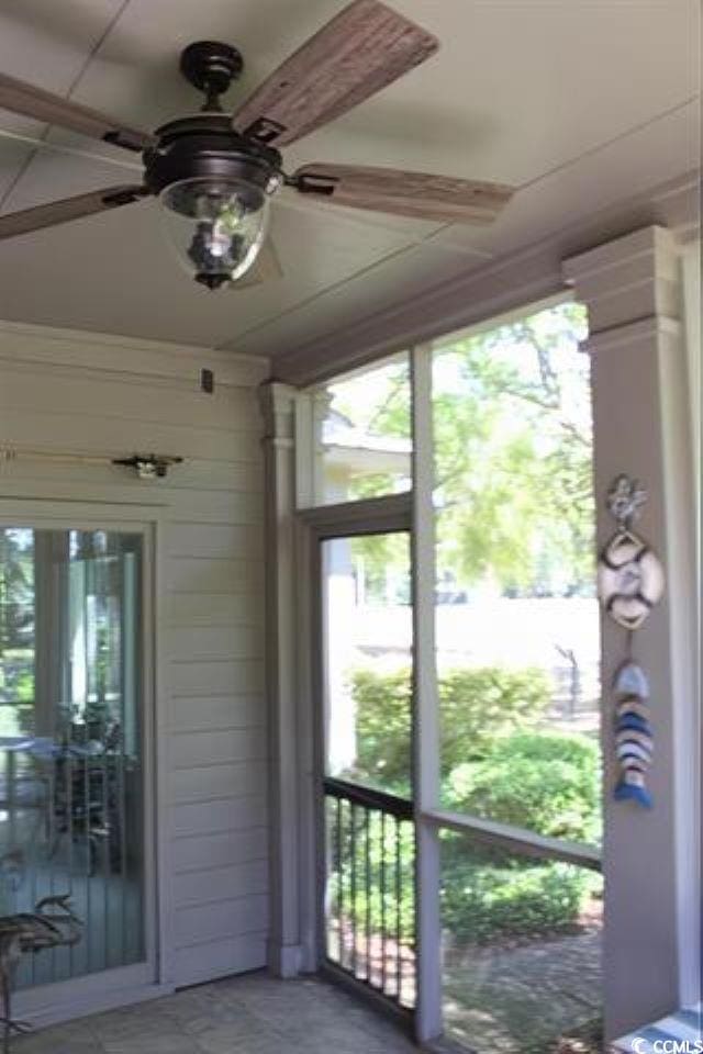 sunroom / solarium featuring ceiling fan and a healthy amount of sunlight