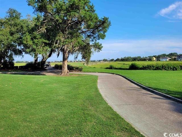 view of property's community featuring a yard