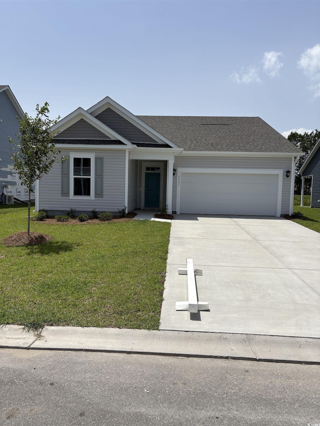 5447 Shelly Lynn Dr, Myrtle Beach, SC 29579 - single story home with concrete driveway, a garage, a front lawn, and roof with shingles