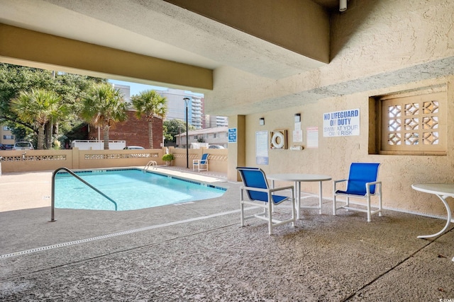 view of swimming pool featuring a patio