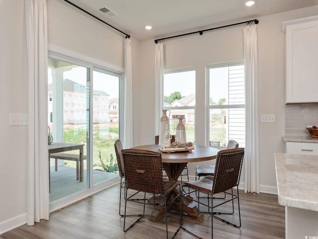 dining space with a healthy amount of sunlight and light hardwood / wood-style floors