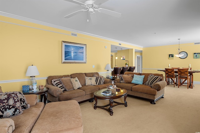 carpeted living room featuring crown molding and ceiling fan