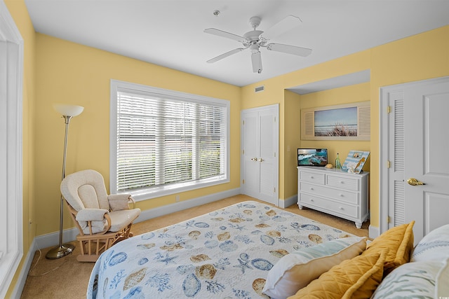 bedroom featuring light colored carpet and ceiling fan