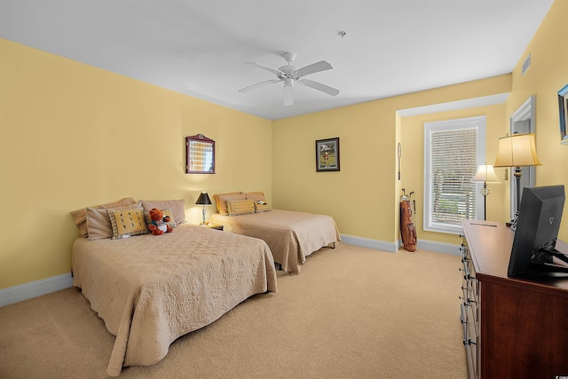 bedroom with light carpet and ceiling fan