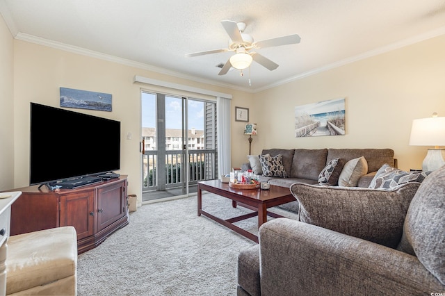 living room featuring ceiling fan, ornamental molding, and light carpet