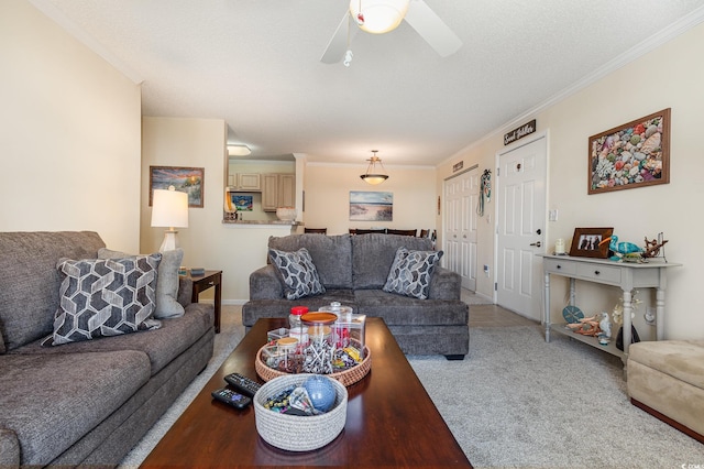 carpeted living room featuring crown molding, a textured ceiling, and ceiling fan