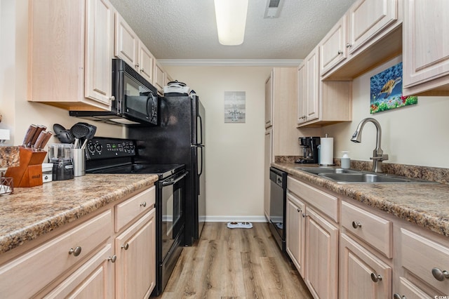 kitchen featuring light brown cabinetry, sink, a textured ceiling, light hardwood / wood-style floors, and black appliances