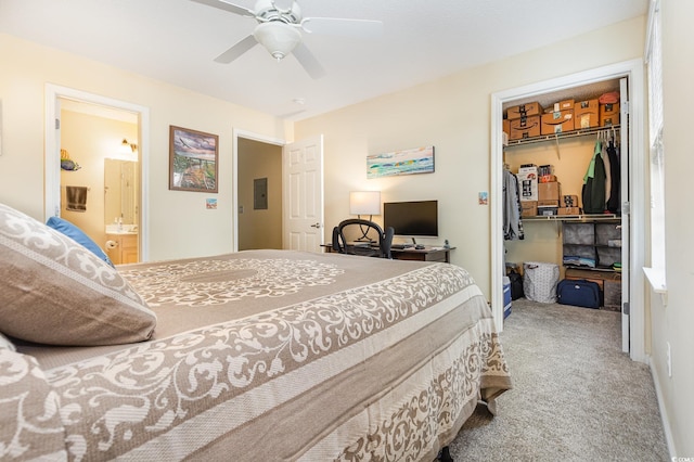 bedroom with ensuite bathroom, a spacious closet, carpet flooring, a closet, and ceiling fan