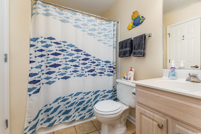 bathroom with vanity, toilet, tile patterned flooring, and a textured ceiling