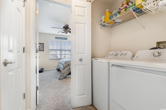 clothes washing area featuring separate washer and dryer, light colored carpet, and ceiling fan