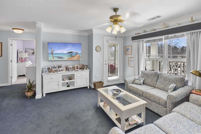 carpeted living room with crown molding and ceiling fan