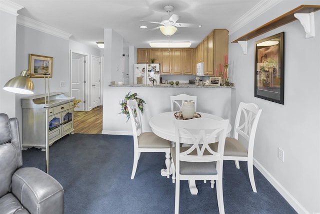 carpeted dining area featuring ornamental molding and ceiling fan