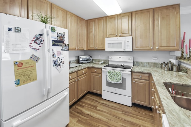 kitchen featuring light wood-type flooring, sink, light stone counters, and white appliances