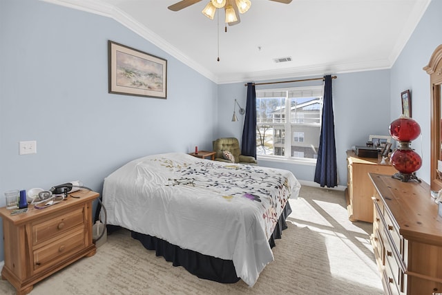 bedroom with ornamental molding, lofted ceiling, light carpet, and ceiling fan