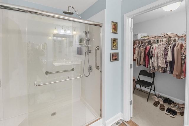 bathroom with a shower with shower door