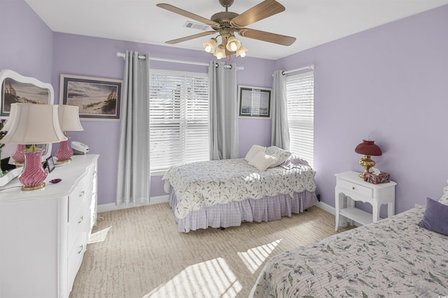 bedroom with multiple windows and ceiling fan