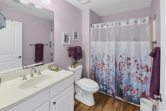 bathroom featuring vanity, hardwood / wood-style flooring, toilet, and a shower with shower curtain