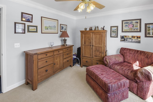 sitting room with light carpet, ornamental molding, and ceiling fan