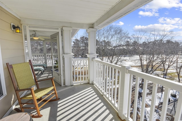 view of snow covered back of property