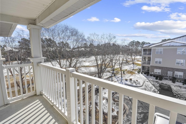 view of snow covered back of property