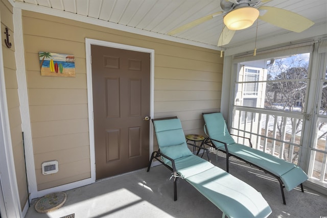 view of exterior entry featuring ceiling fan and covered porch