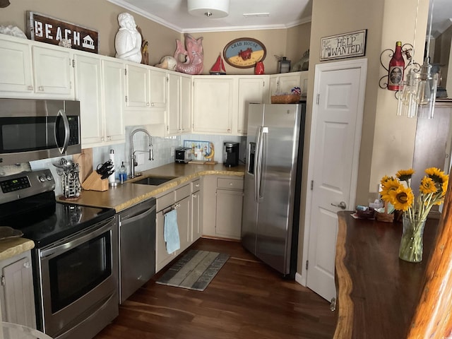 804 Brenda Pl, Myrtle Beach, SC 29577 - kitchen featuring stainless steel appliances, dark wood-style flooring, ornamental molding, backsplash, and white cabinetry