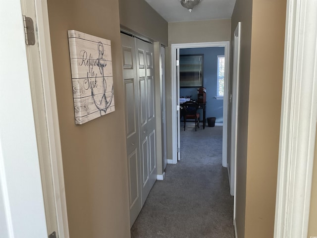 hallway featuring dark colored carpet