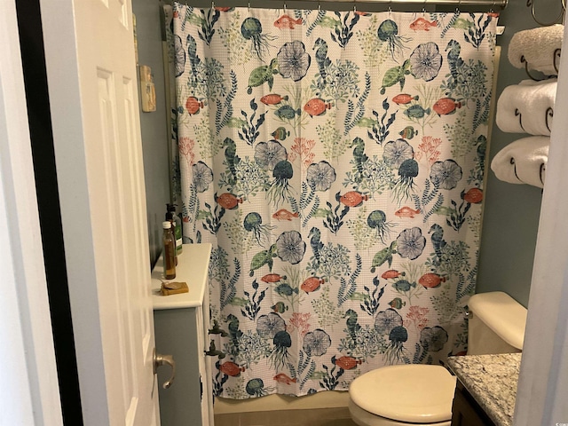 bathroom with walk in shower, vanity, and toilet