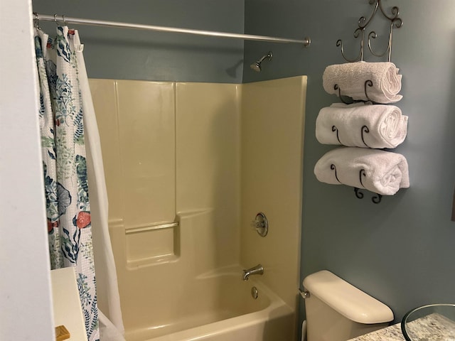 bathroom with toilet and shower / tub combo