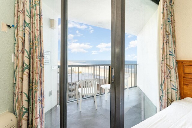 9550 Shore Dr Unit 722, Myrtle Beach, SC 29572 - bedroom with concrete flooring, a water view, access to outside, and a view of the beach