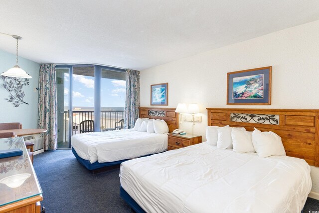 9550 Shore Dr Unit 722, Myrtle Beach, SC 29572 - bedroom with expansive windows, access to outside, and dark colored carpet