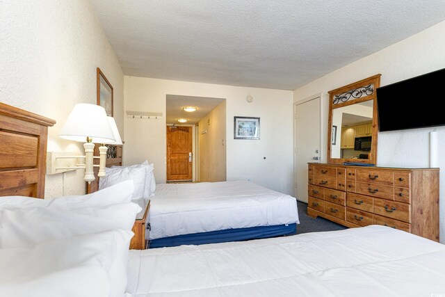 9550 Shore Dr Unit 722, Myrtle Beach, SC 29572 - bedroom with a textured ceiling