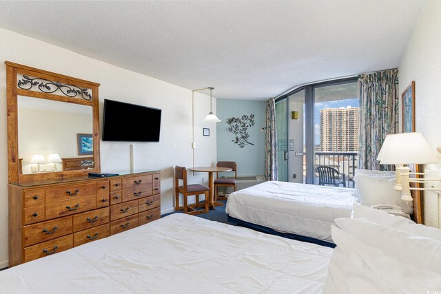 9550 Shore Dr Unit 722, Myrtle Beach, SC 29572 - bedroom with a wall of windows, access to exterior, and a textured ceiling