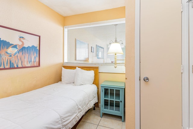 bedroom featuring light tile patterned floors