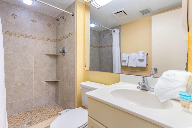 bathroom featuring walk in shower, vanity, and toilet